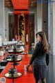 A woman in a business suit standing in front of a long table.