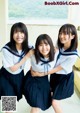 A group of young women in school uniforms posing for a picture.