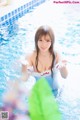 A woman in a blue and white bathing suit in a pool.